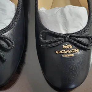 Coach Black Flats with Elegant Bow and Logo.