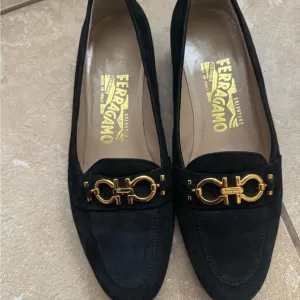 Salvatore Ferragamo Black and Gold Flats